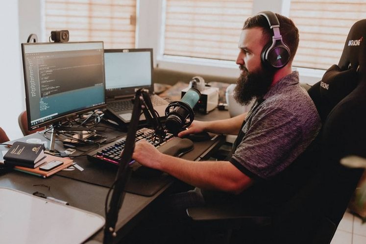 Carlos Villa coding at his studio desk
